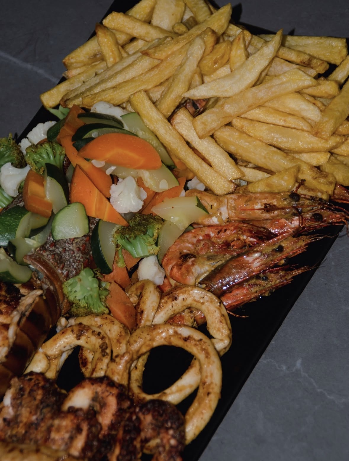 Seafood platter with prawns, calamari and vegetables