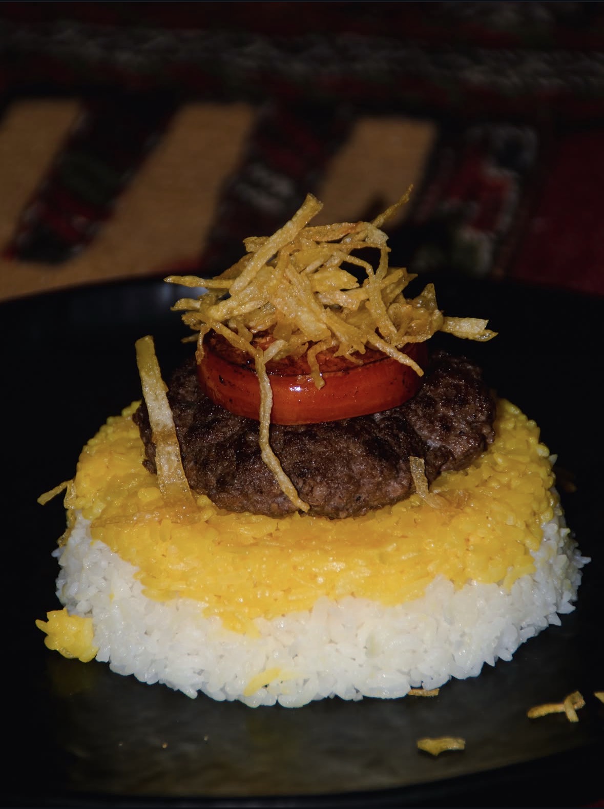 Signature beef patty over saffron rice