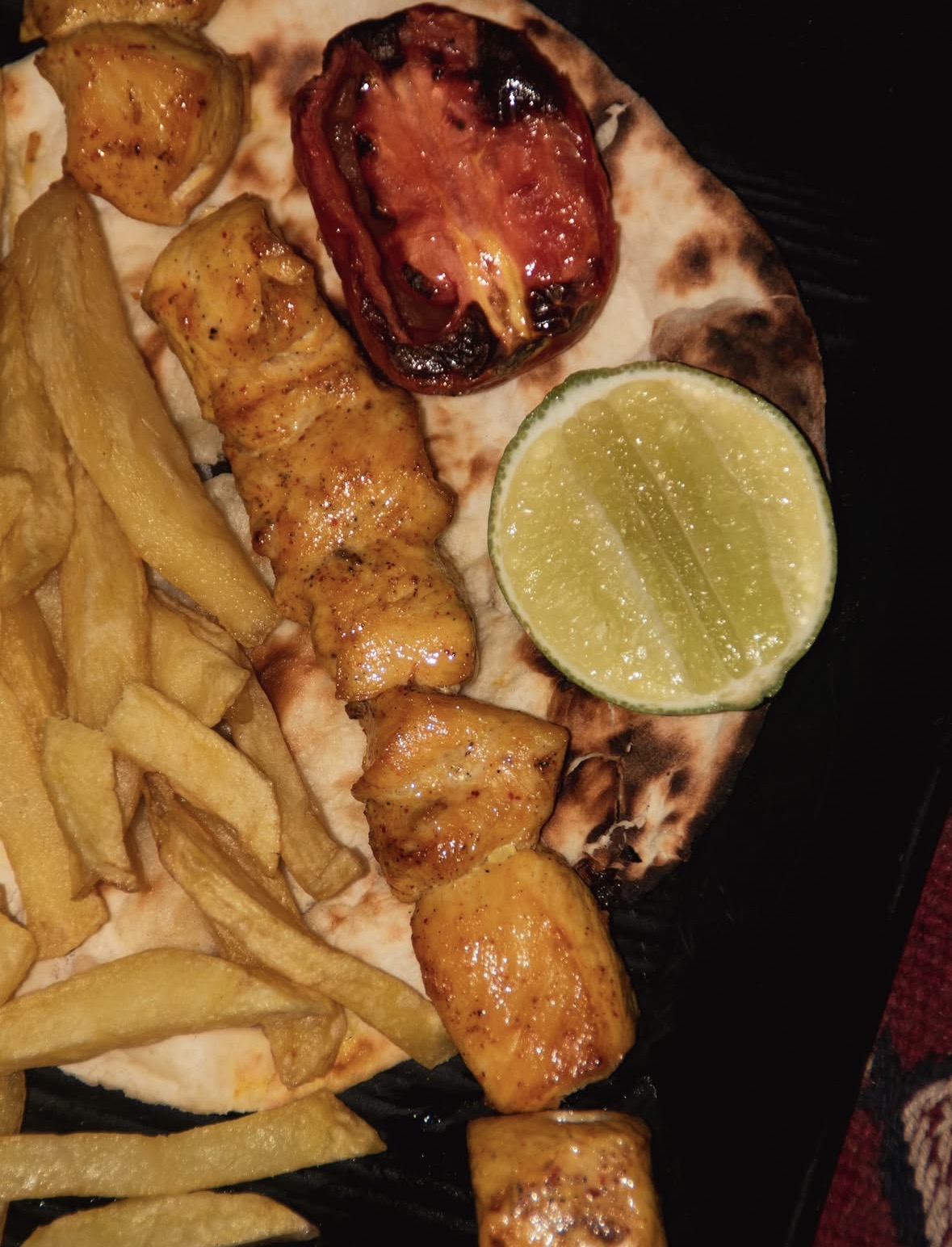 Jujeh kabab with saffron chicken and fries